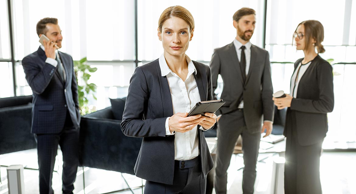 portrait of a female lawyer with team indoors