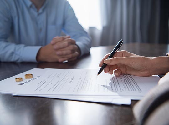 couple at table with divorce document