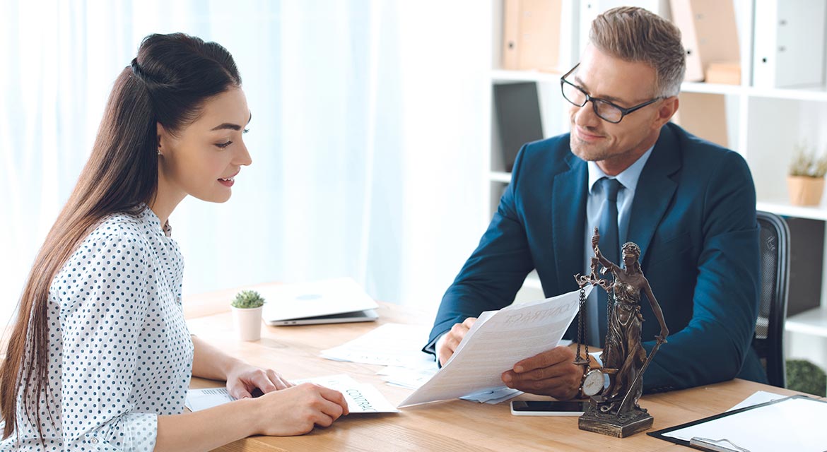 smiling lawyer showing papers to happy client